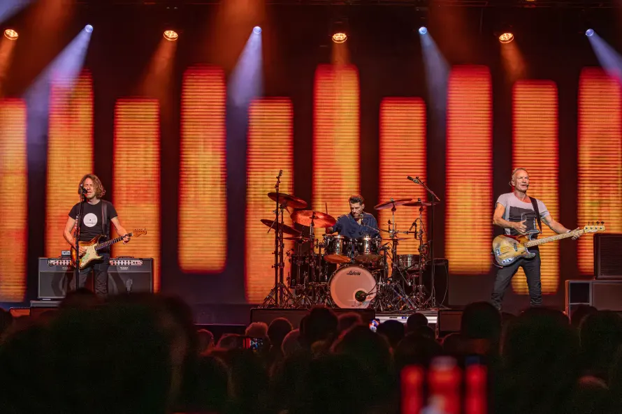 sting-dominic-miller-and-chris-maas-are-performing-on-a-stage.webp