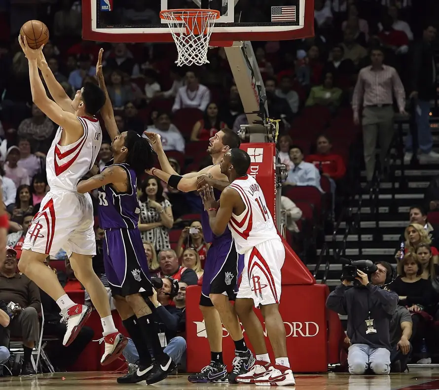 a-player-drives-to-the-hoop-in-a-tense-basketball-game.webp
